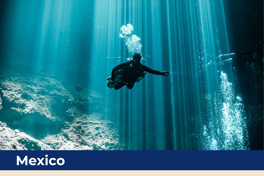 Scuba diver exploring an underwater cenote in Mexico.